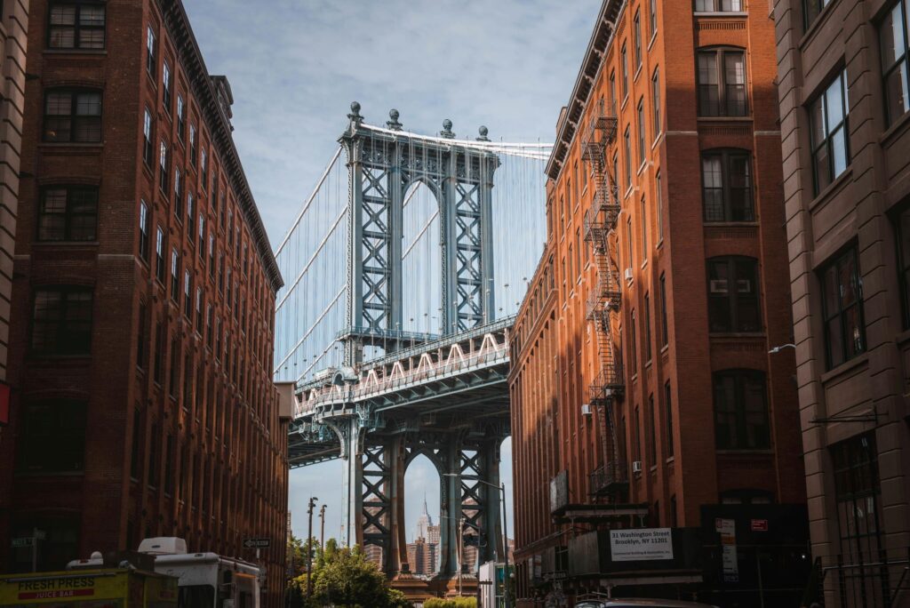 the brooklyn bridge framed between two buildings