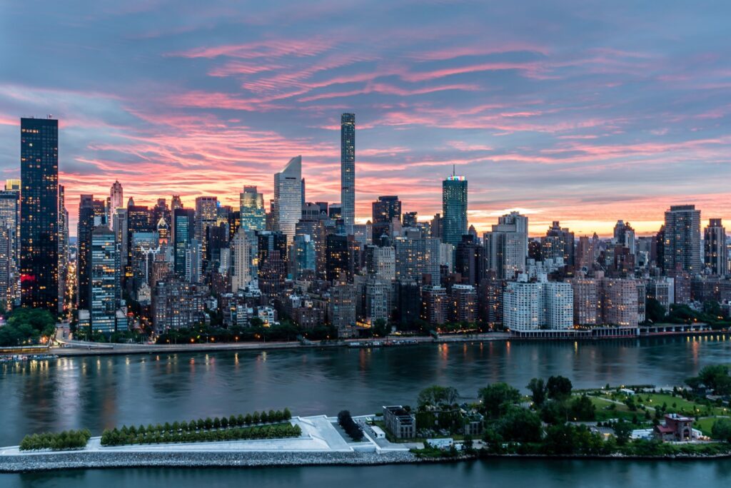 new york city skyline view from a new york charter bus and the sky is illuminated