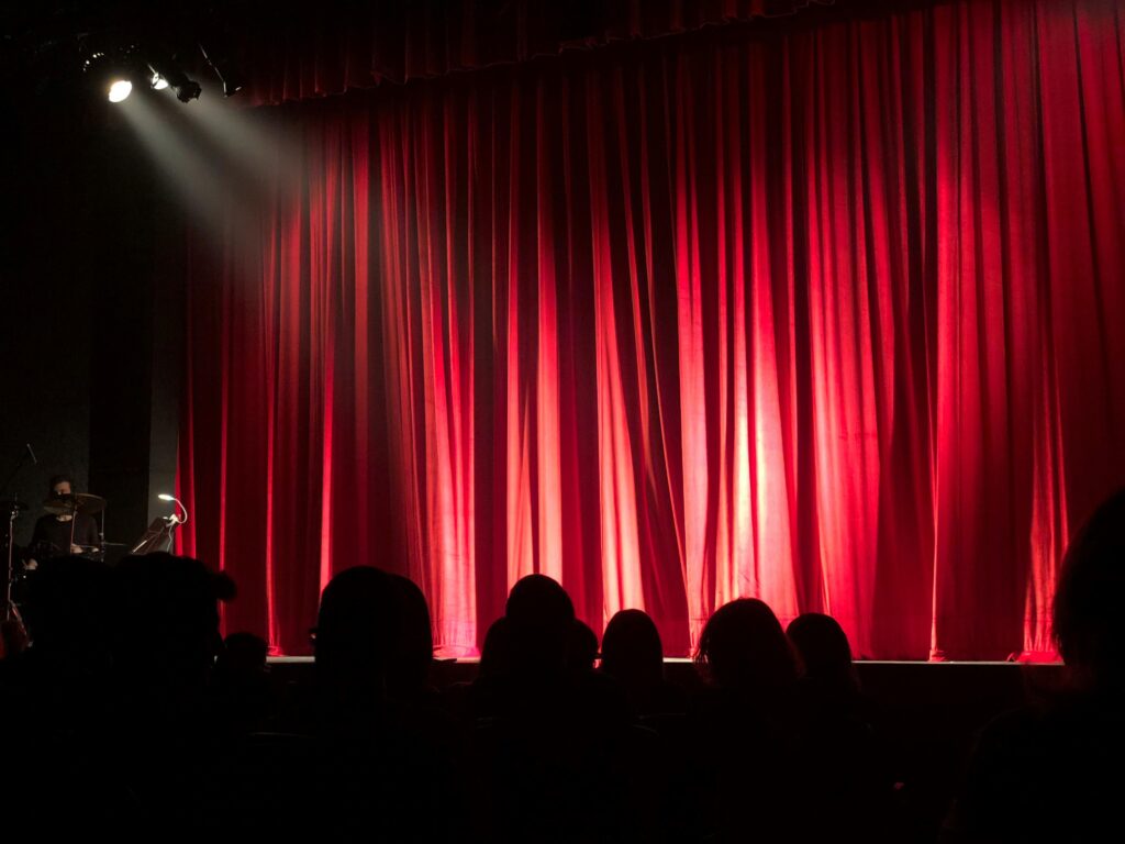 red curtain and an audience